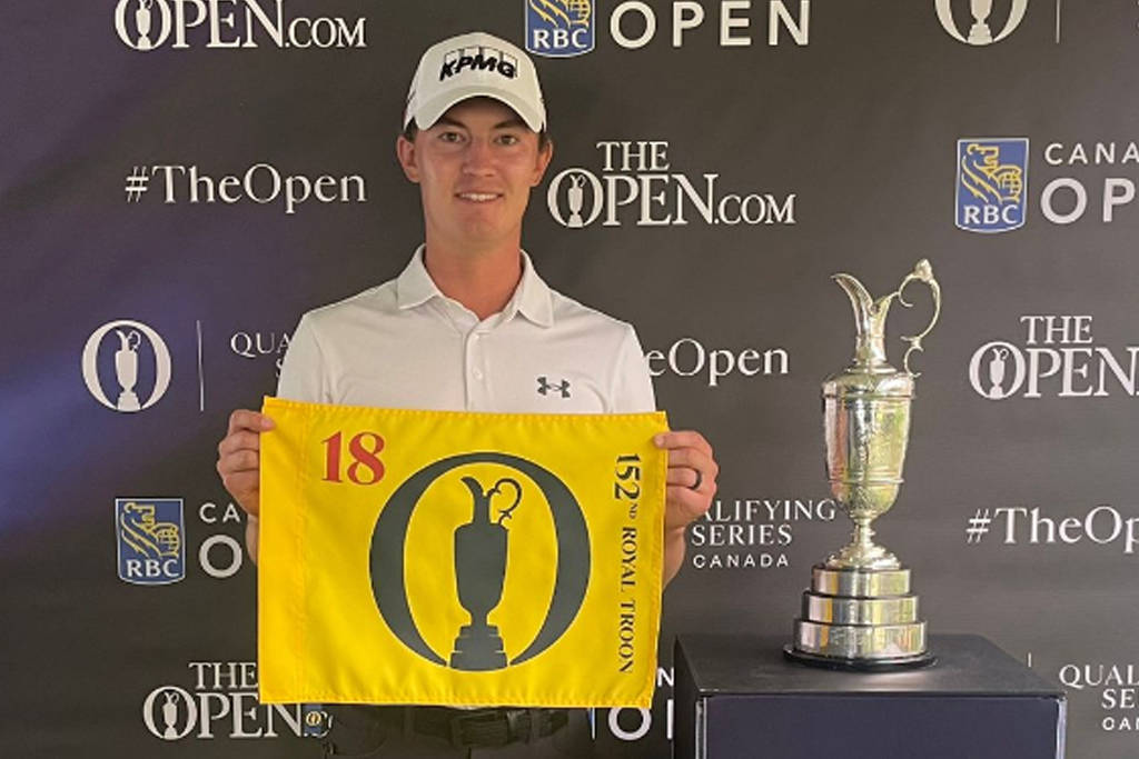Maverick McNealy poses with an Open pin flag after qualifying for The 152nd Open